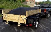 Dump Trailer with load properly tarped with standard Roll Tarp